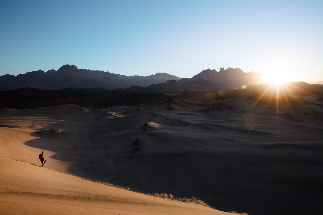 A traveler at sunset in a dramatic landscape