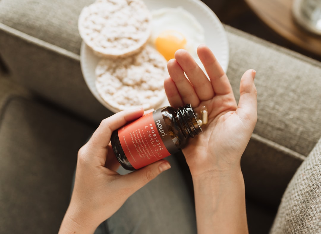 Woman taking supplements in the morning with probiotic capsules